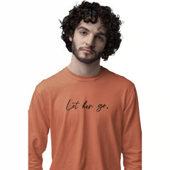 Man wearing an orange long-sleeve shirt with 'Let her go.' text on a white background