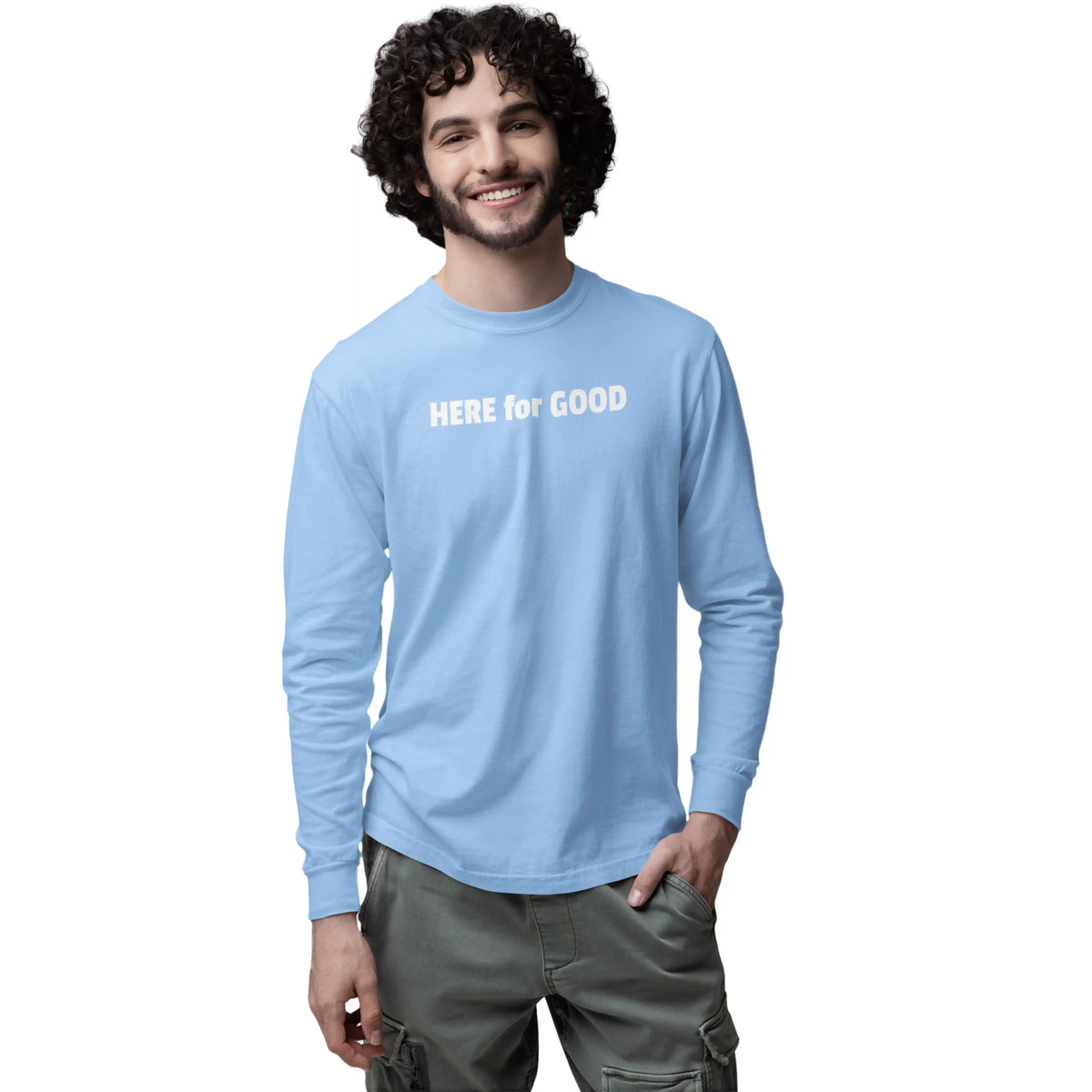 Man wearing a light blue long-sleeve shirt with 'HERE for GOOD' text on a white background