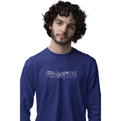 Man wearing a blue long-sleeve shirt with 'CREATIVE' text on a white background