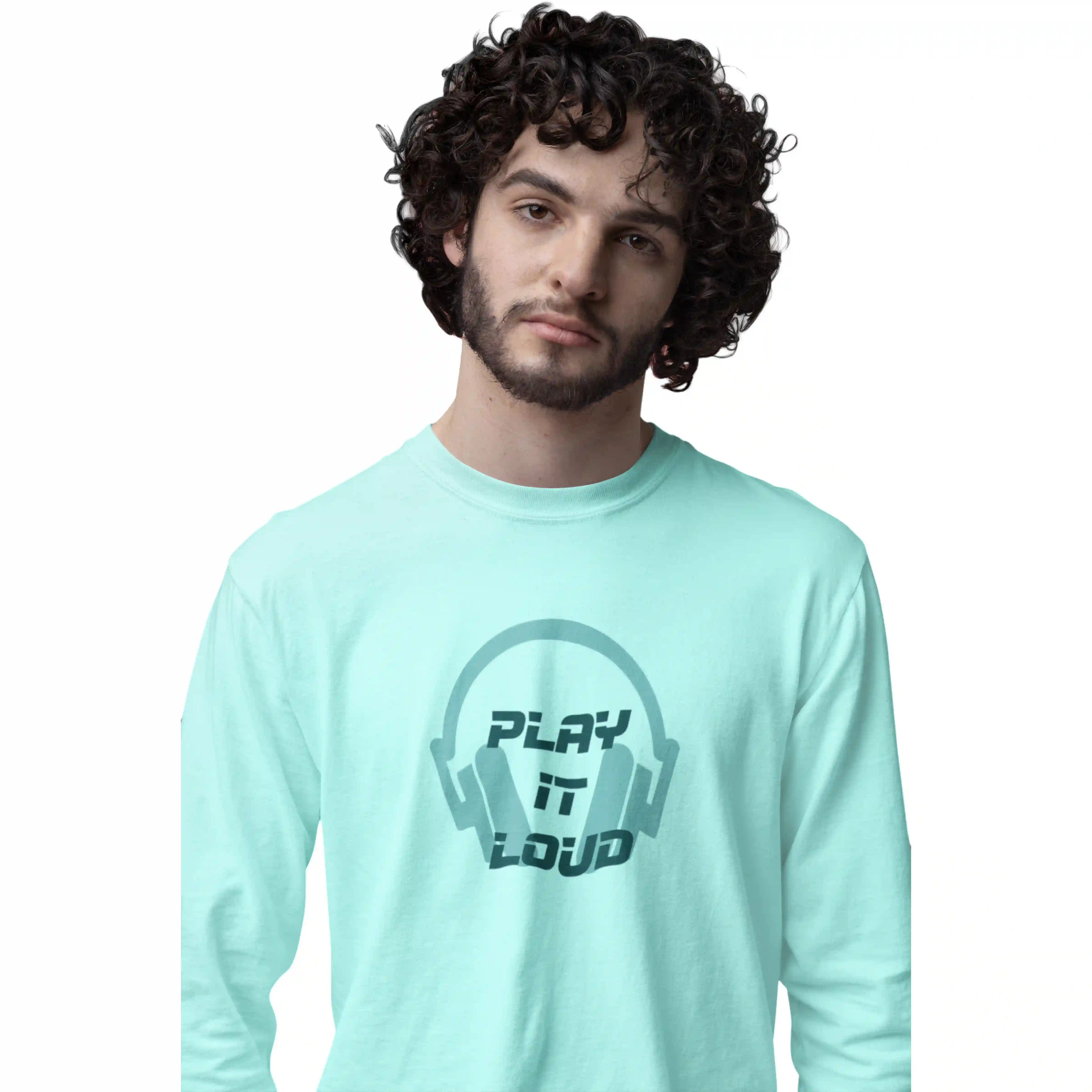 Person wearing a light blue t-shirt with 'Play It Loud' design on a white background