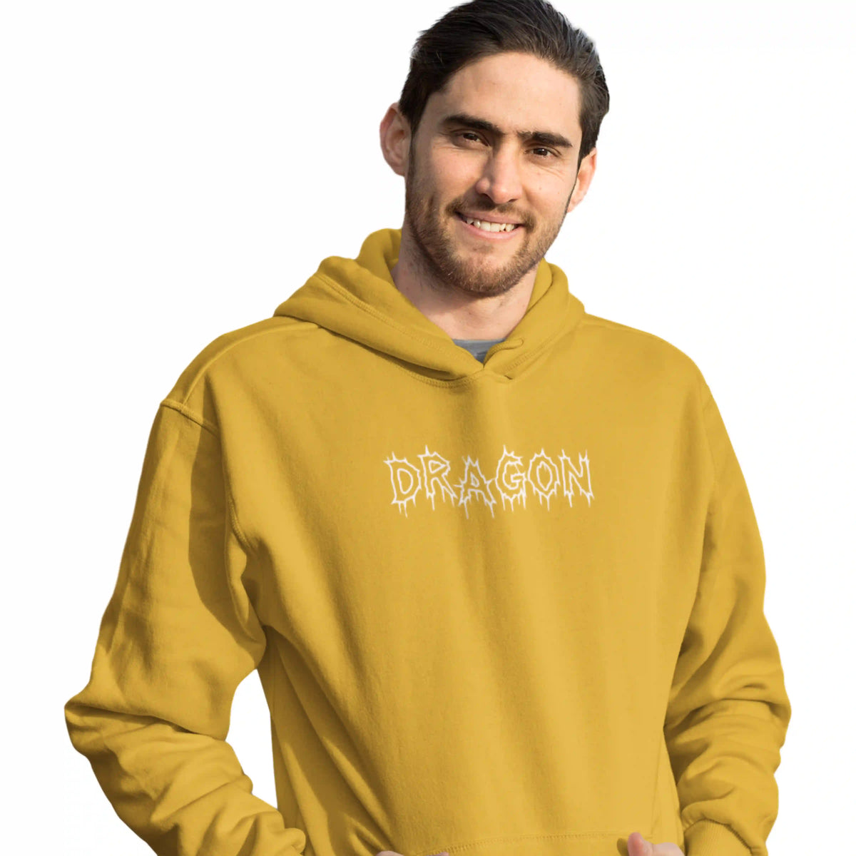Man wearing a mustard yellow hoodie with 'DRAGON' printed on it against a white background